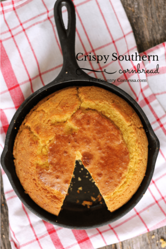 baked cornbread in a cast iron skillet on a red napkin