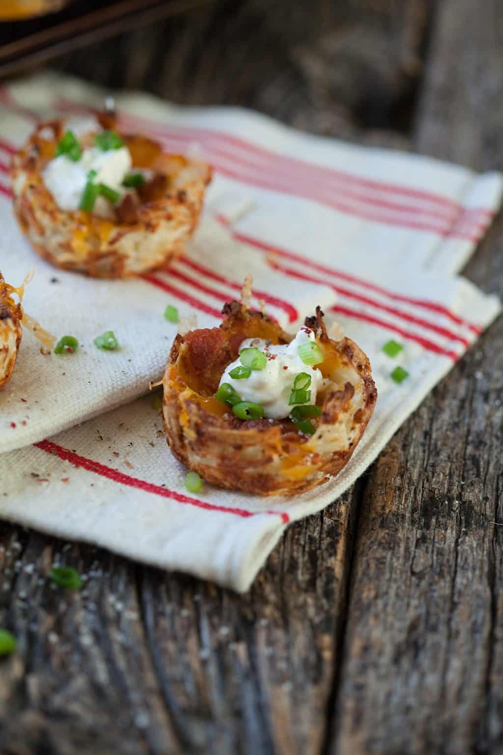 Loaded hash brown potato skins take away all the messy baking, scraping and remaking of a traditional potato skin and make it simple, affordable and tasty!