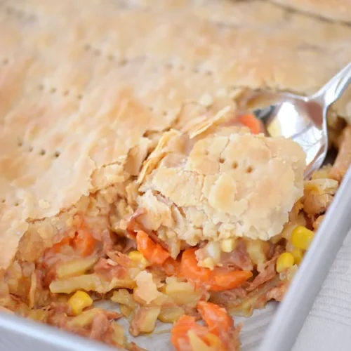 ham pot pie with spoon in baking dish