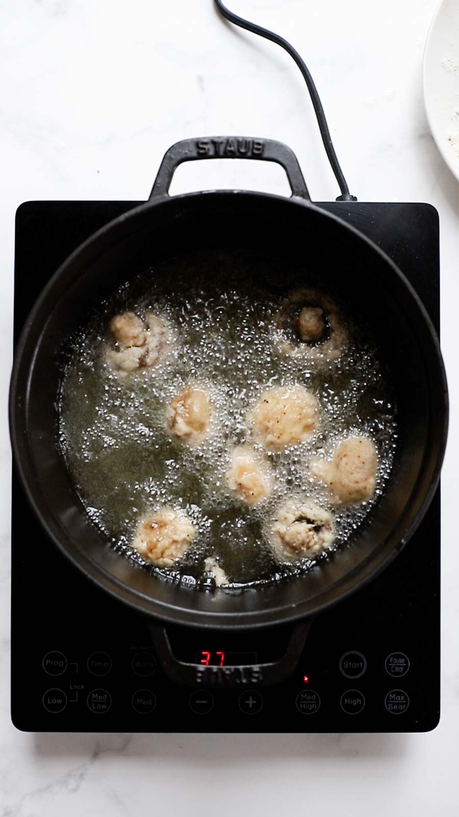Frying mushrooms in hot oil.