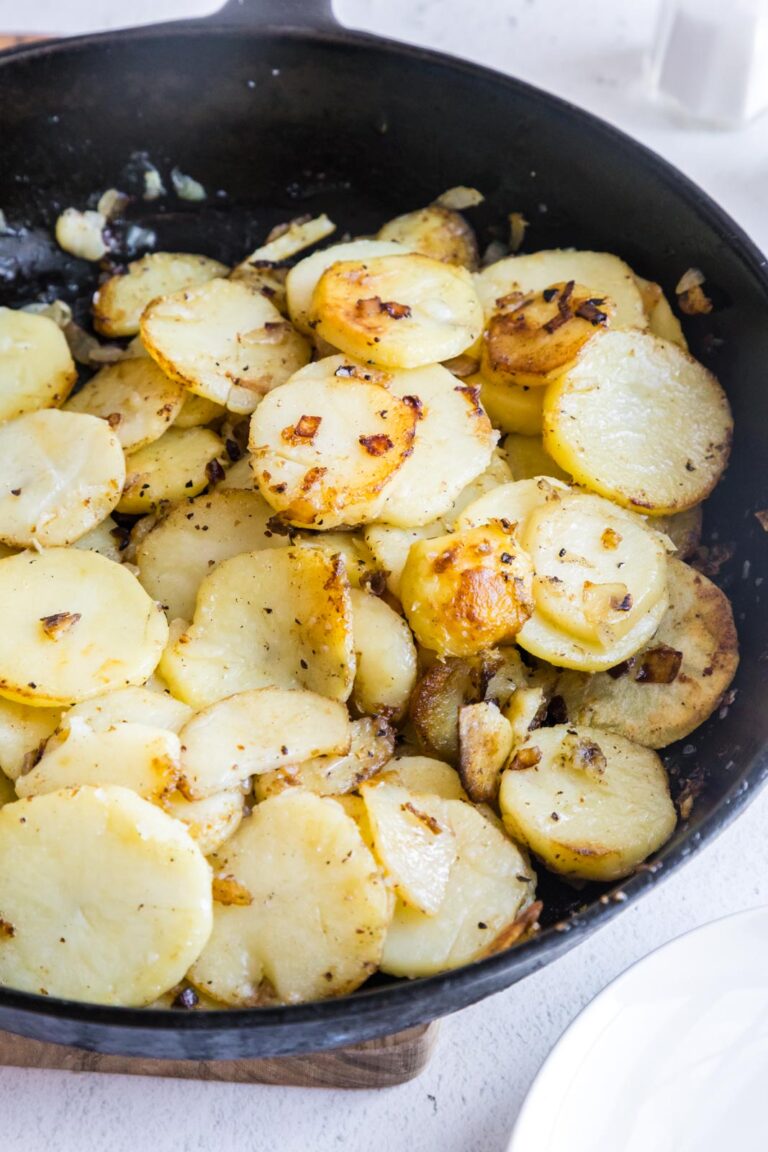 a skillet of southern fried potatoes and onions on a table