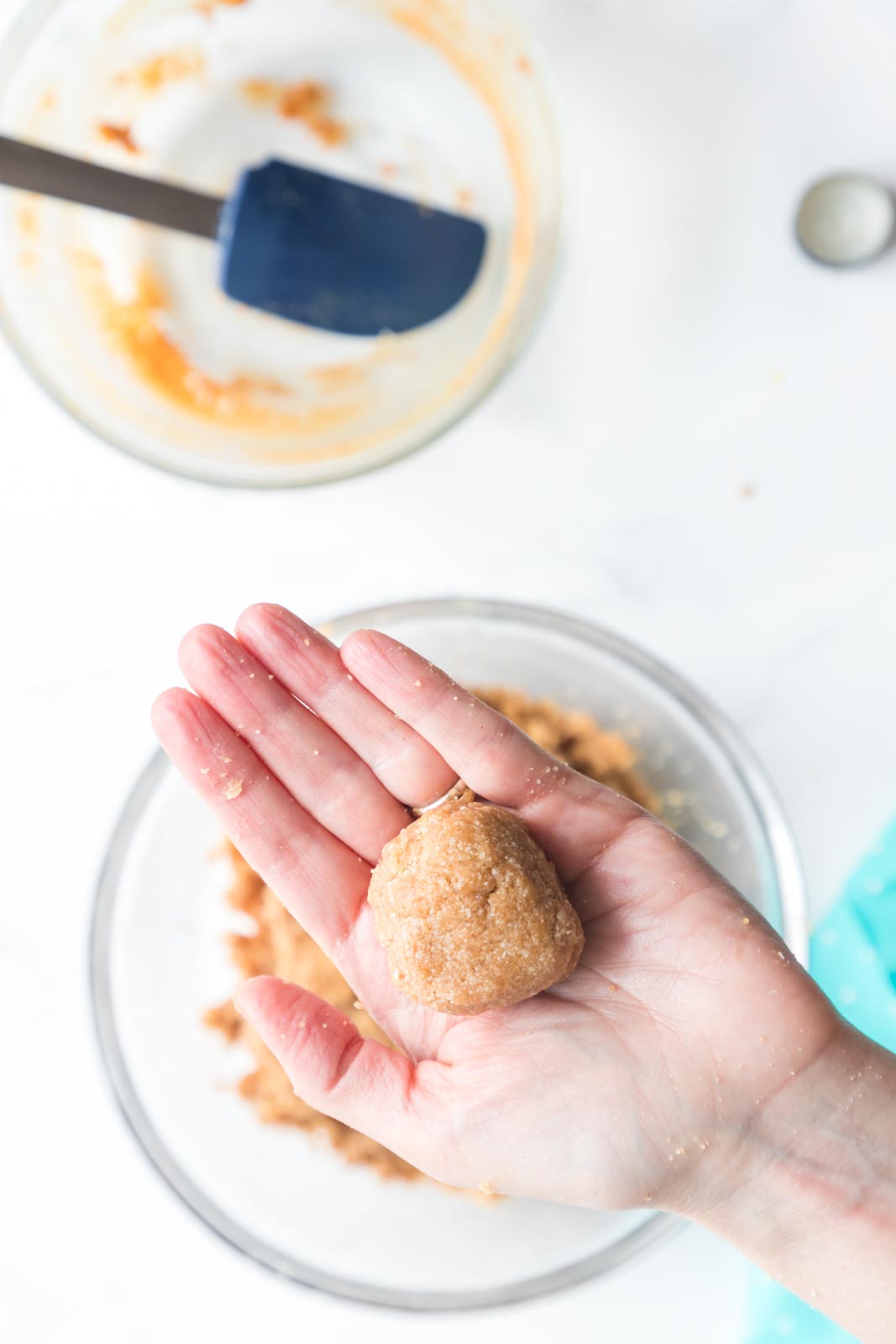 a ball of cookie dough held in a hand