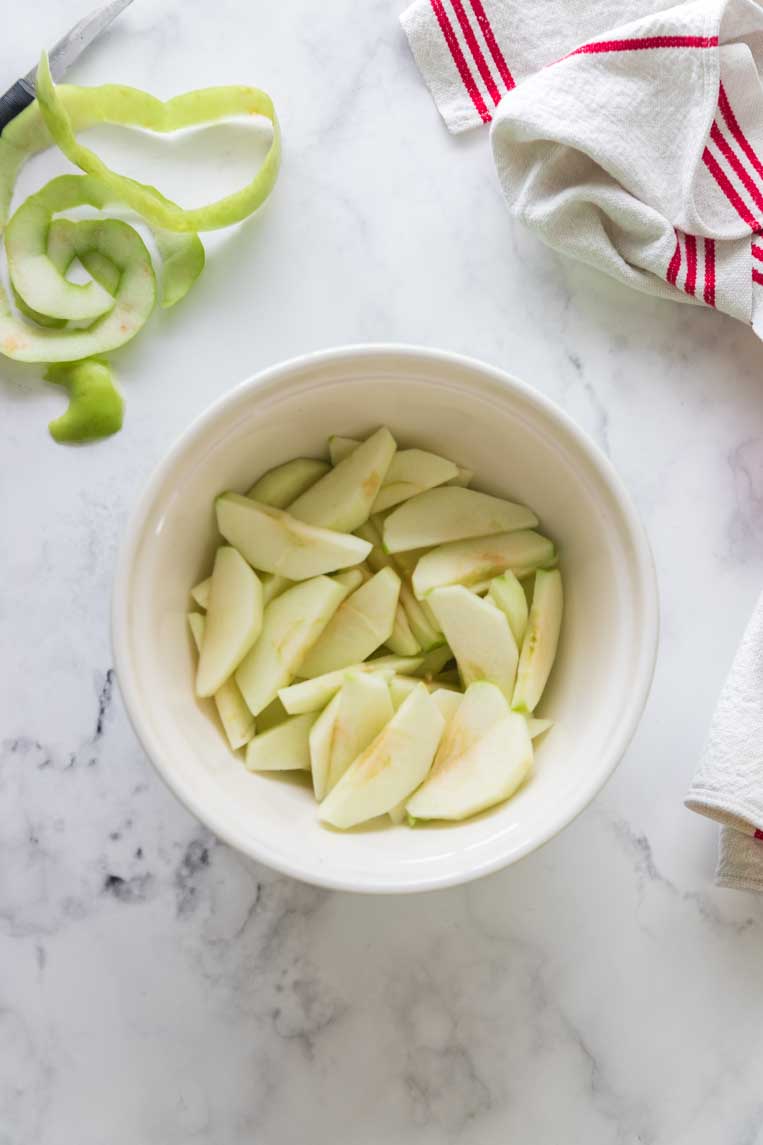 a bowl of sliced and peeled apples in a bowl 