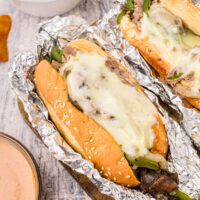 a philly cheesesteak in foil with melted cheese