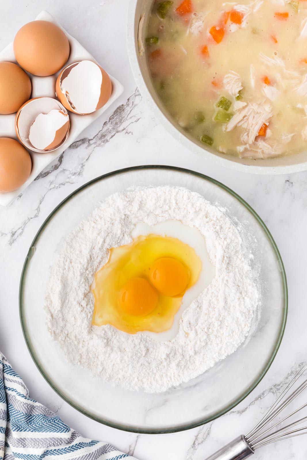 two eggs in a bowl of self rising flour to make drop dumplings 