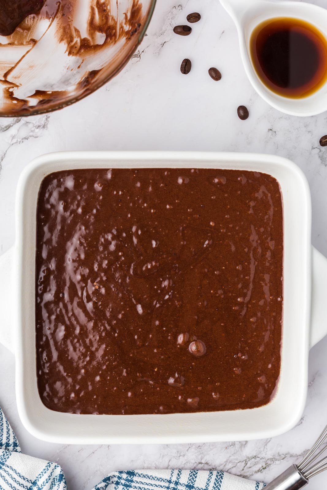 an 8x8 pan of brownie batter ready for the oven