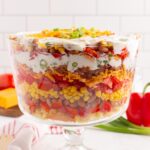 Cornbread salad in a trifle dish ready to toss and serve.