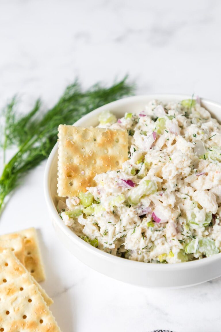 Crab salad in a bowl with a cracker.