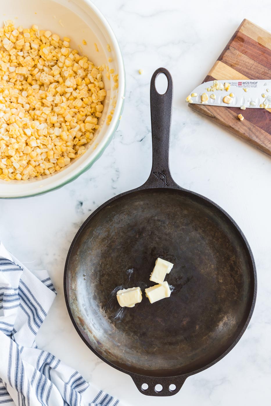 skillet with butter ready to melt and bowl of corn kernels