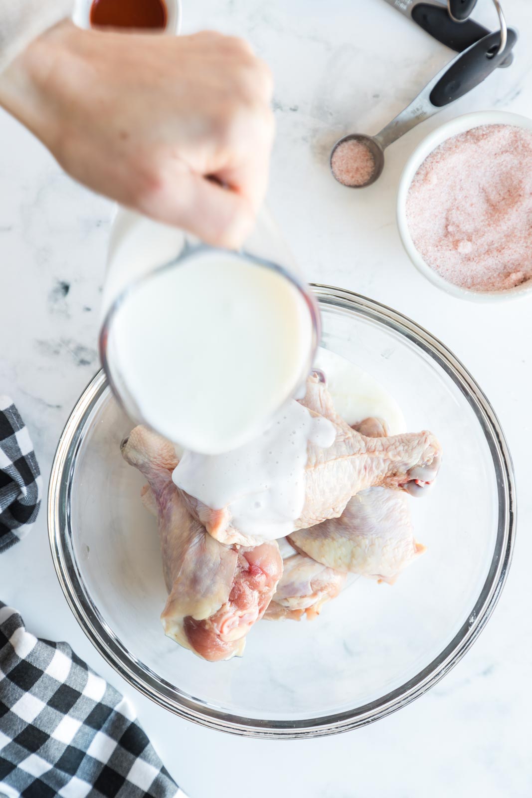 pouring buttermilk on chicken legs