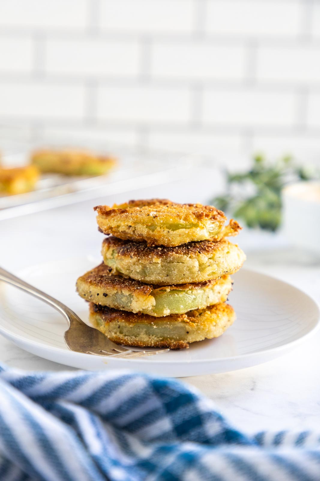 a stack of fried green tomatoes on a plate 
