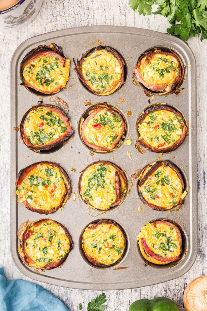 A 12 cup muffin tin with baked egg muffin cups.