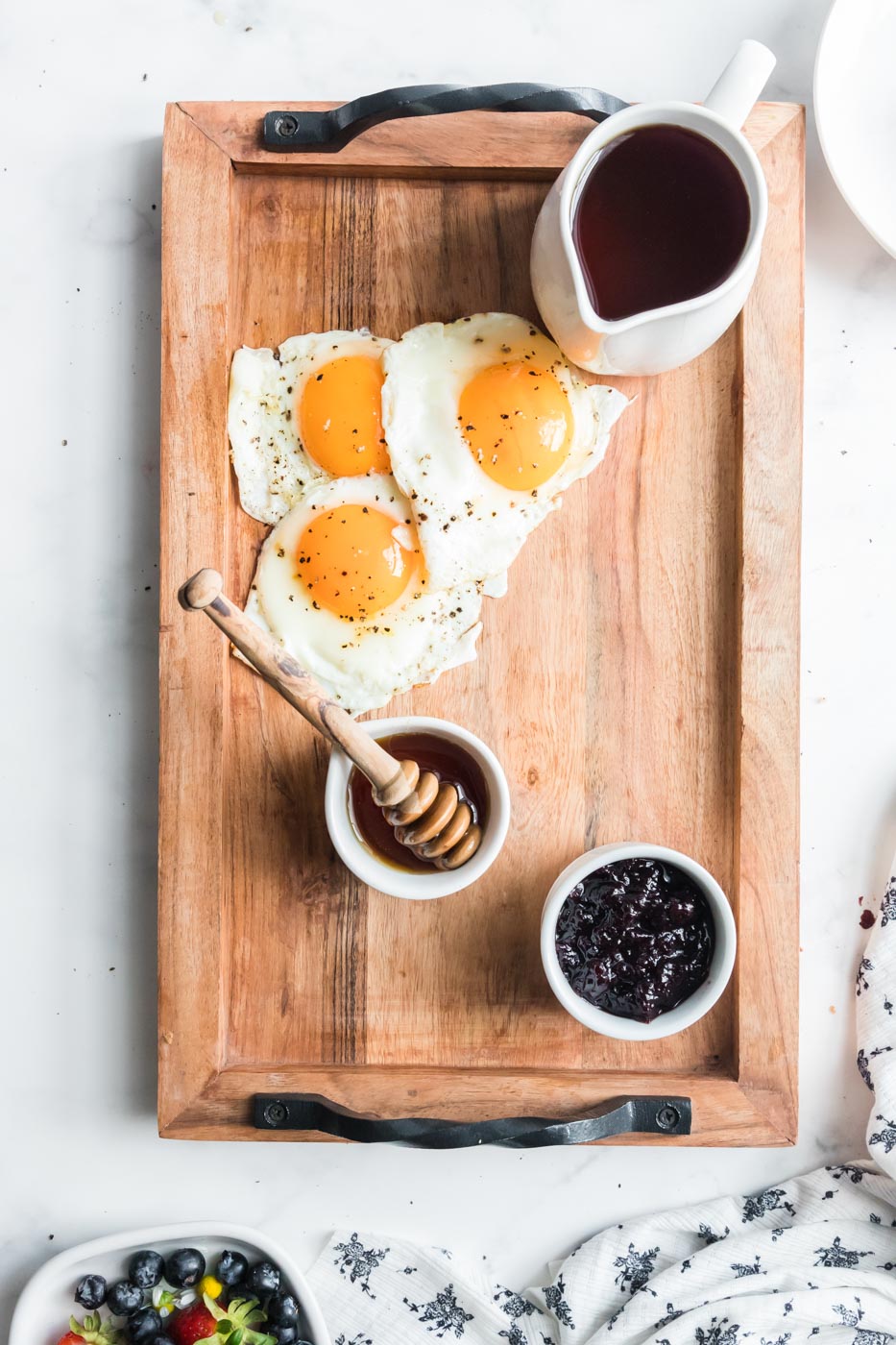 eggs sunny side up arranged on breakfast charcuterie board
