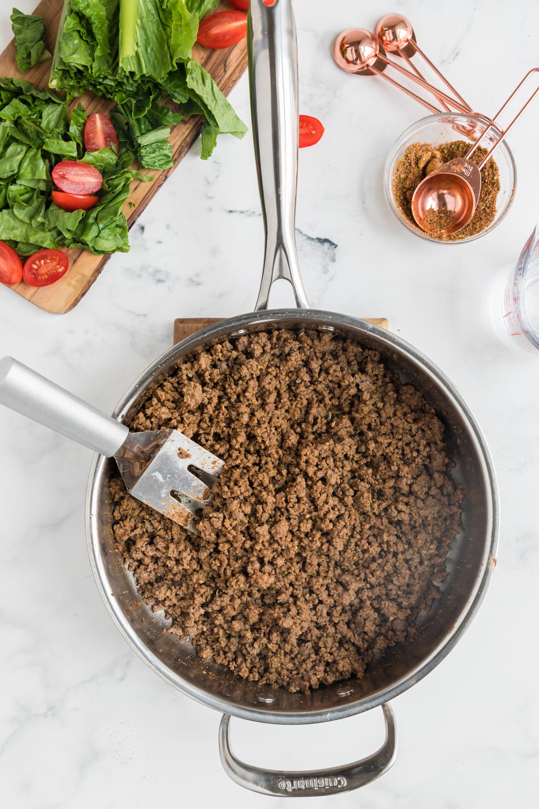 a skillet of ground beef with taco seasoning added 