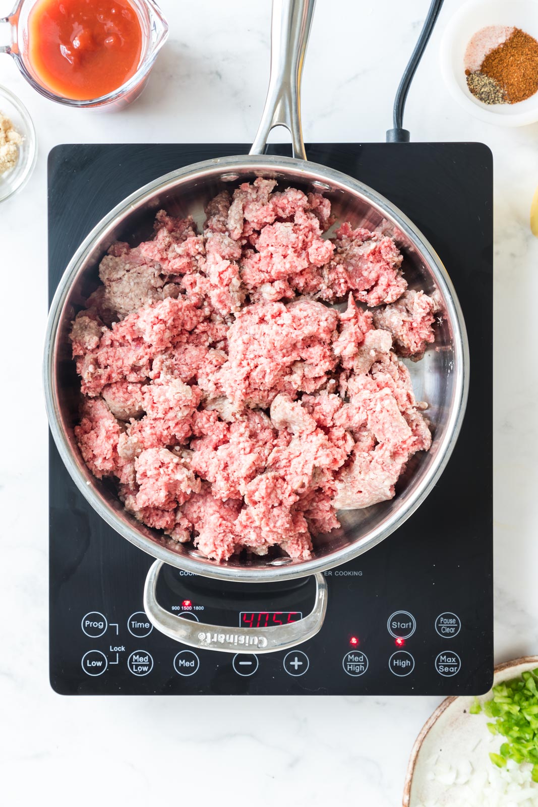 a skillet of uncooked ground beef in a skillet