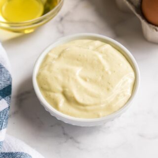 a bowl of mayonnaise with eggs and oil