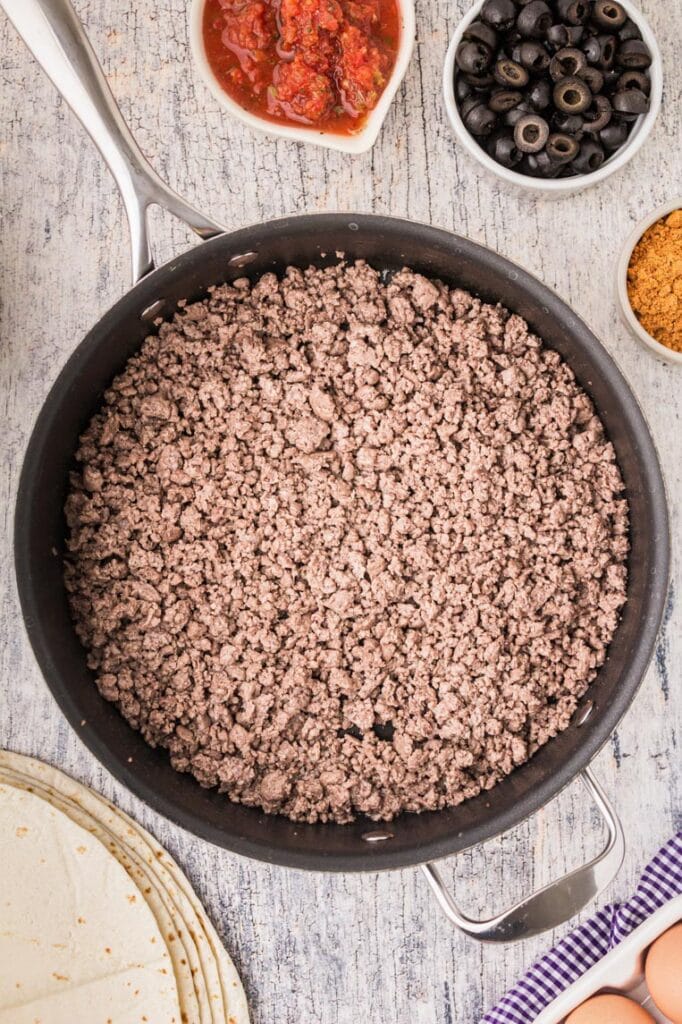 A skillet of ground beef cooked and crumbled 