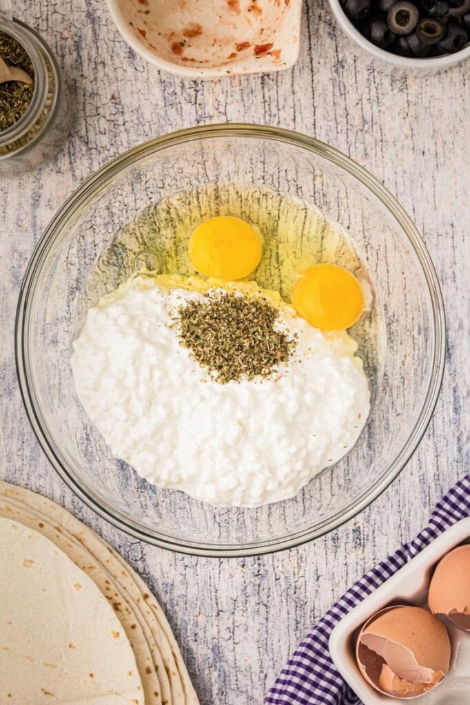 Eggs, cottage cheese, oregano in a bowl 