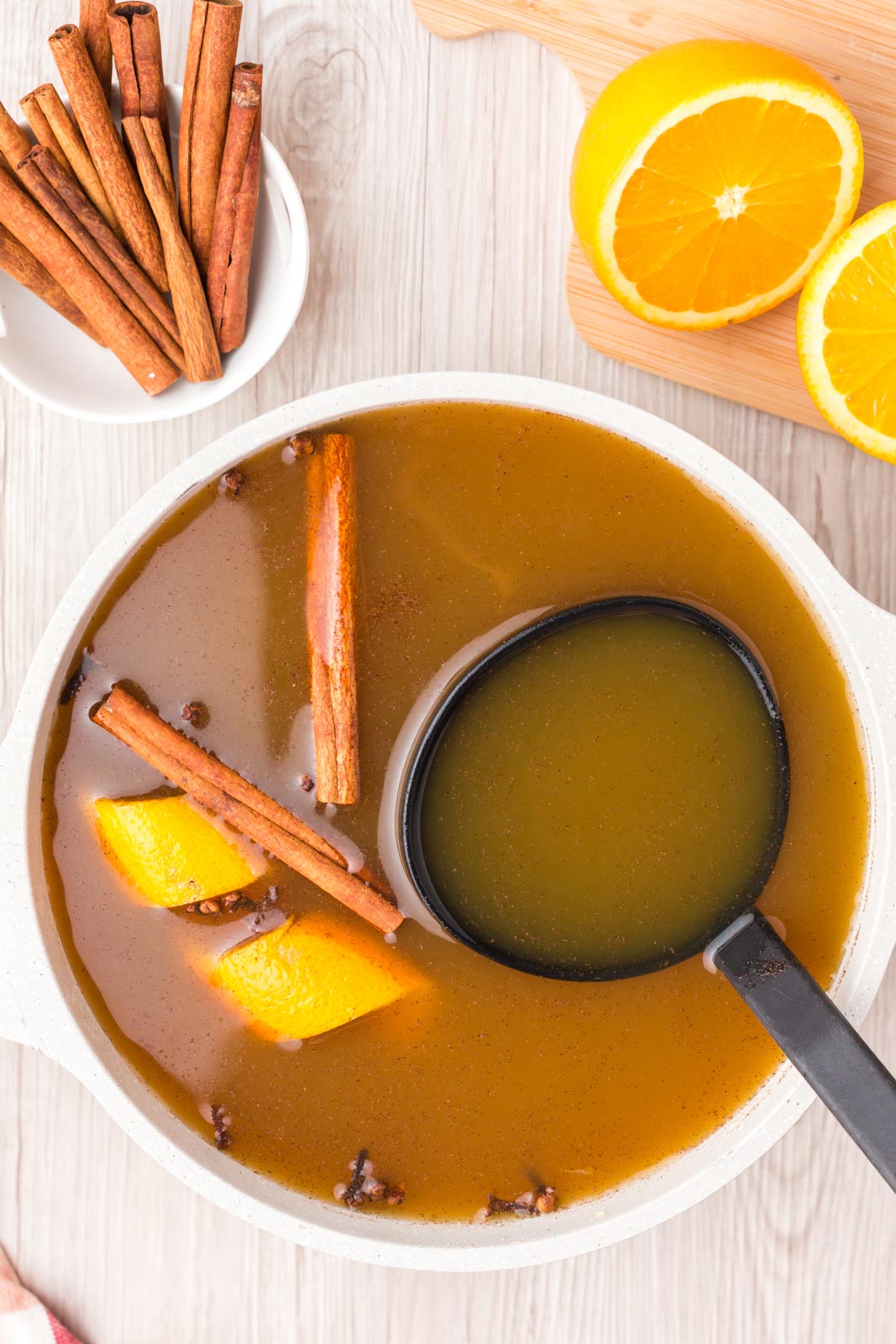overhead bowl of mulled cider with a ladle 