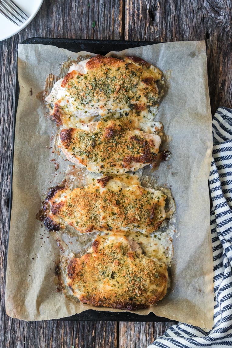 a cookie sheet with baked mayo chicken parmesan