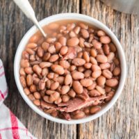 a bowl of pinto beans with a spoon