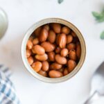 a can of pinto beans with the top off looking down inside