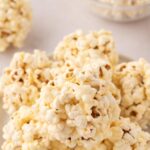 a stack of marshmallow popcorn balls on a plate