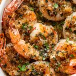 close up of baked shrimp oreganata in a baking dish