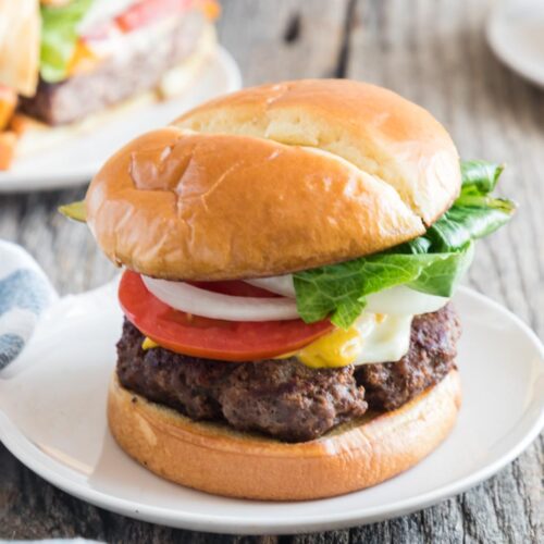 easy skillet hamburger on bun with cheese lettuce onion tomato