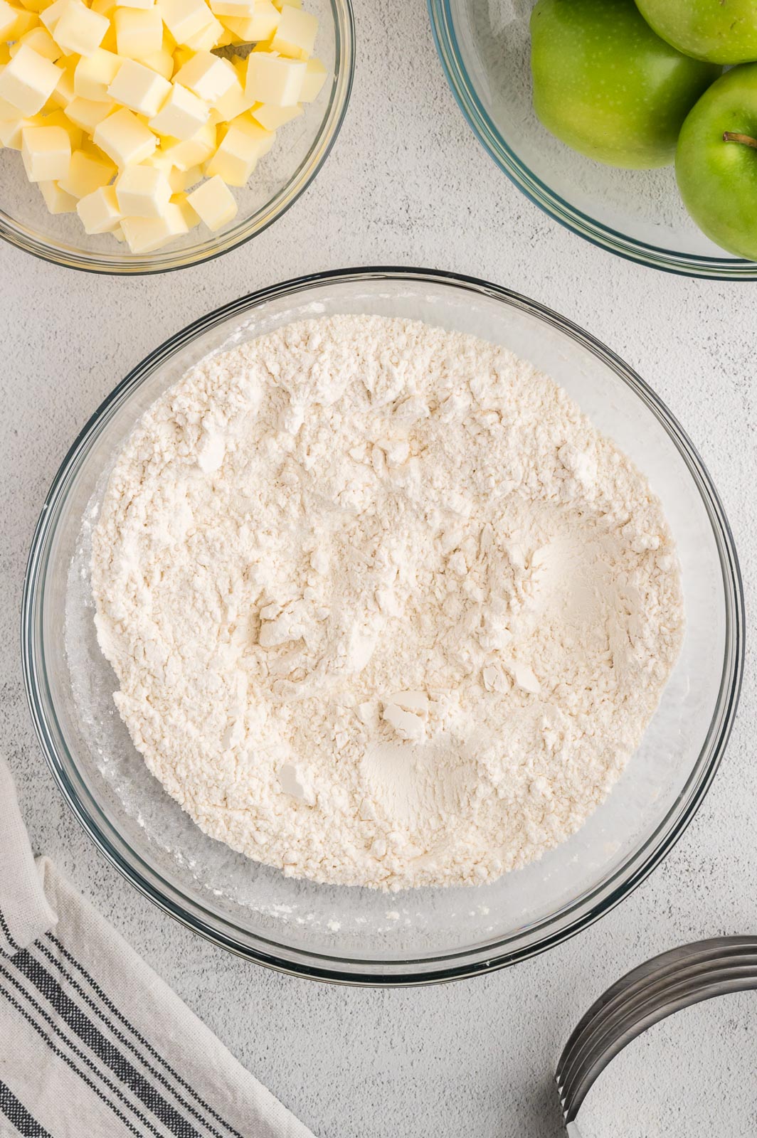 a bowl of flour on a table for pie crust 