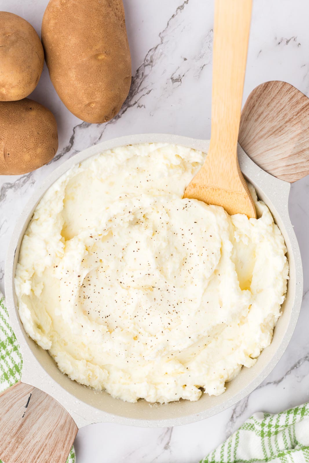 a bowl of sour cream mashed potatoes with a spoon in the bowl 