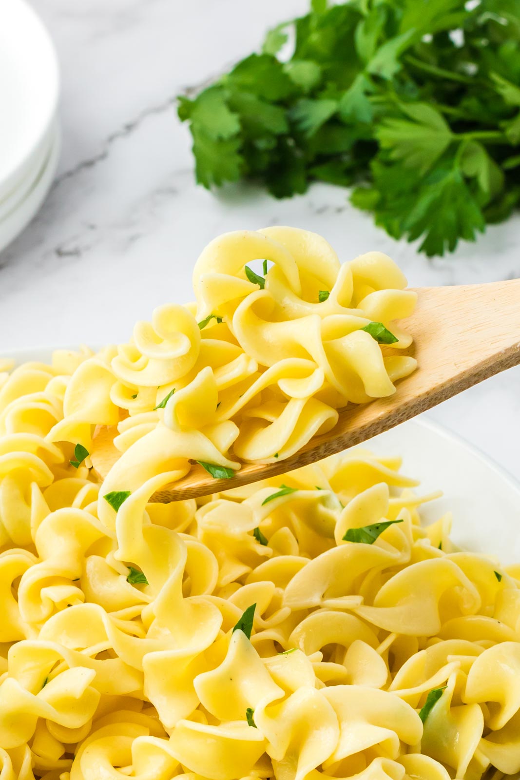 a close up of egg noodles on a spoon