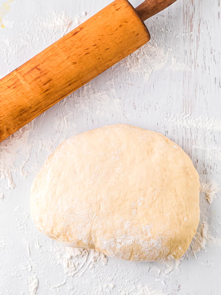 a ball of dough ready to roll with a rolling pin