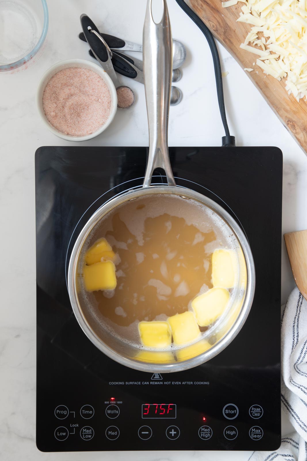 a pot of chicken broth with butter added and heated 