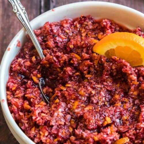 a bowl of cranberry orange relish with a spoon in it