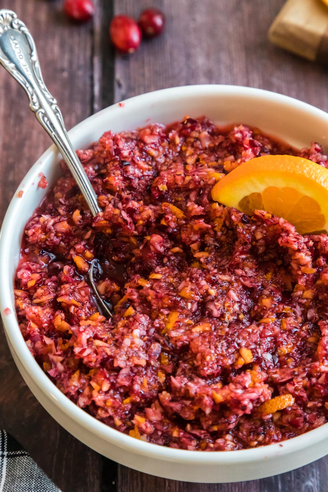 a bowl of cranberry orange relish with a spoon in it 