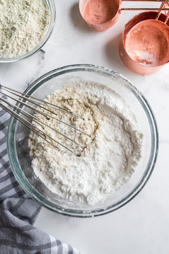 a bowl of gluten free flours being whisked together