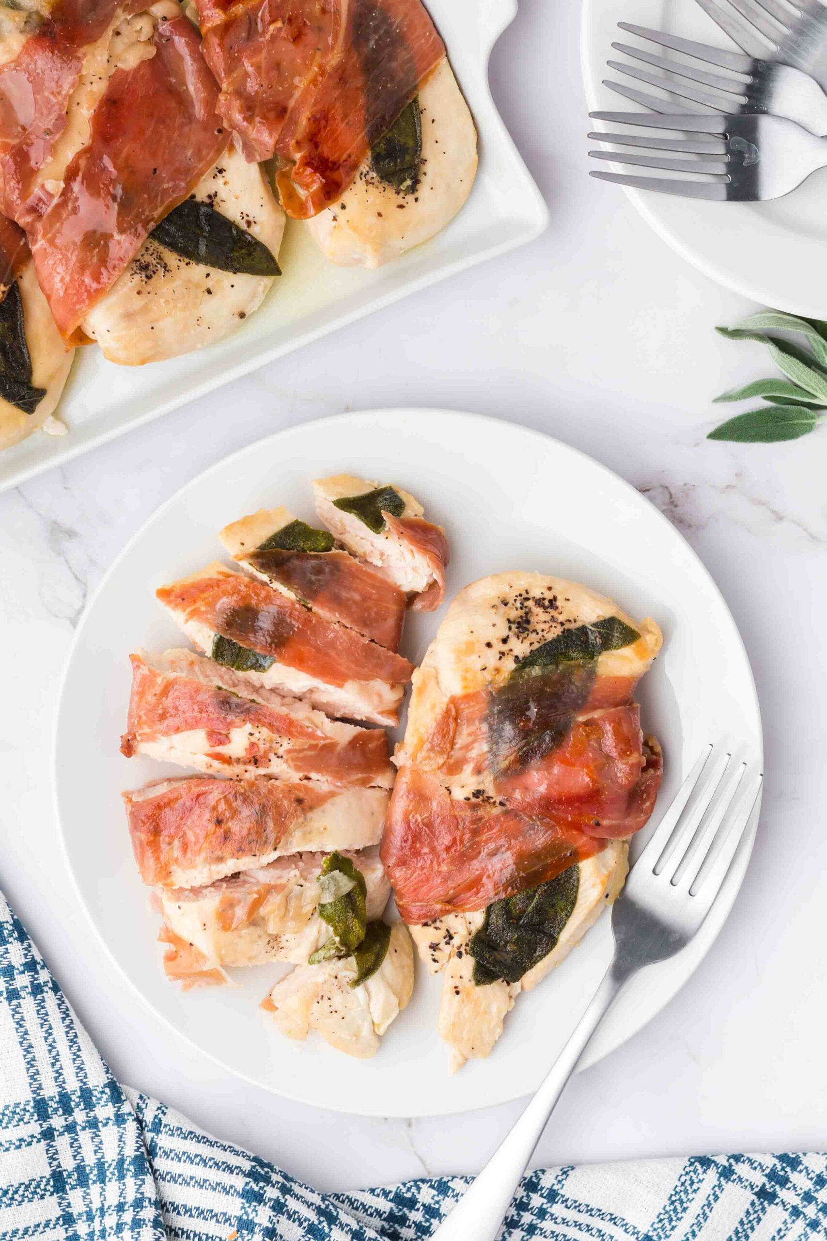 sliced chicken saltimbocca on a plate