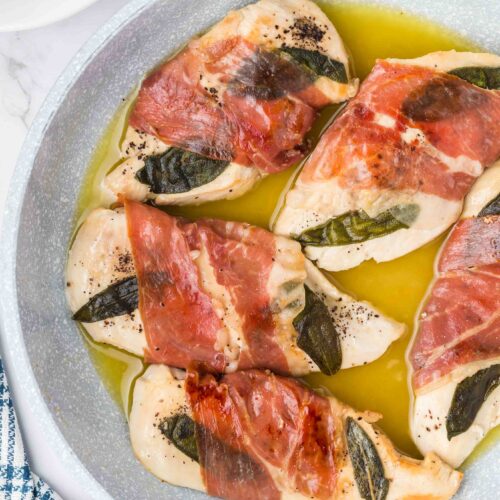 a skillet of chicken saltimbocca on a table ready to serve