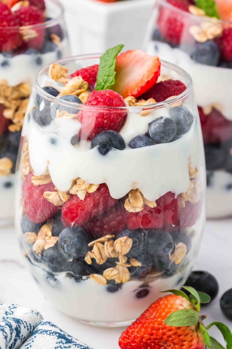 a cup of fruit and yogurt parfait on a table