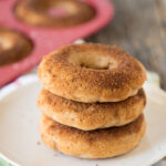 three baked apple cider donuts on a plate