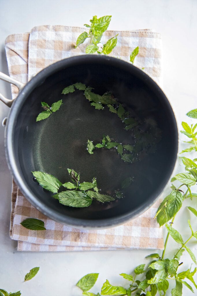a pot with peppermint leaves steeping for tea