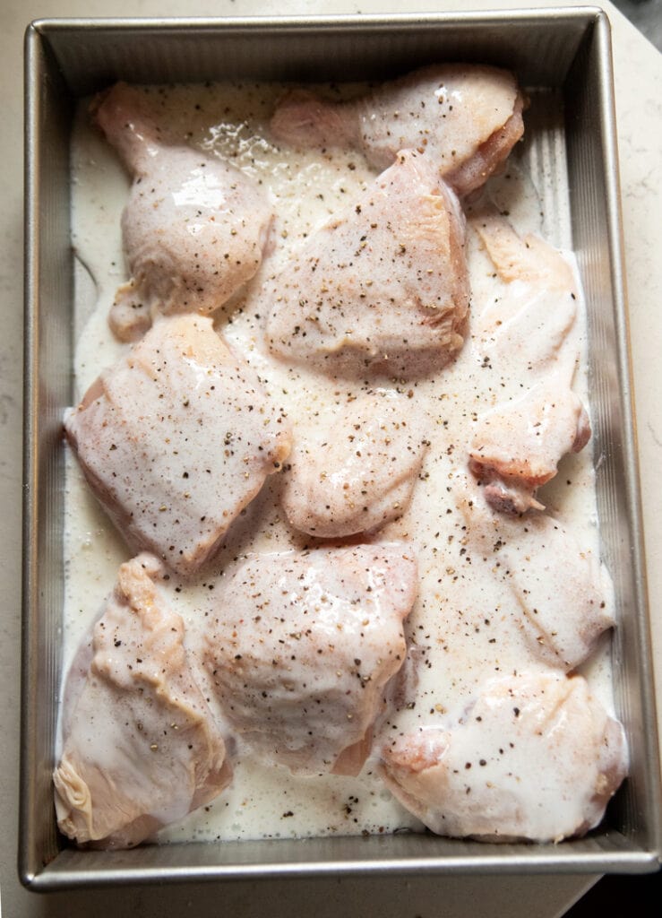 a pan of chicken in buttermilk brine