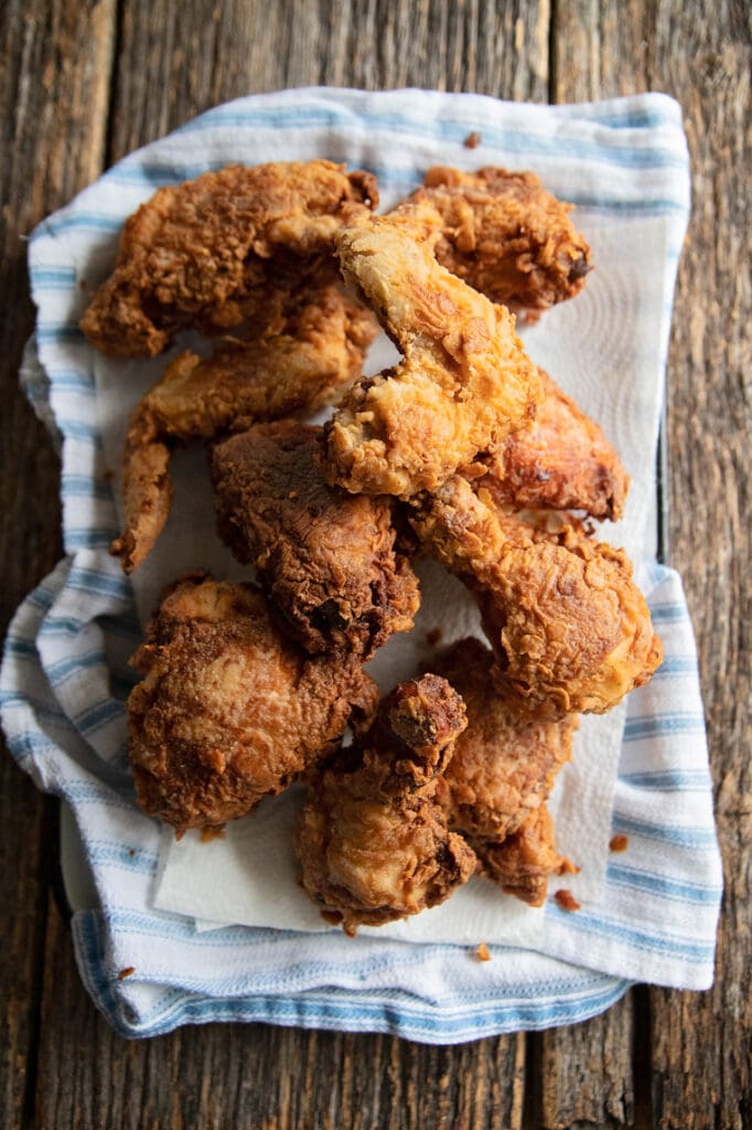 A platter of buttermilk fried chicken on a table.