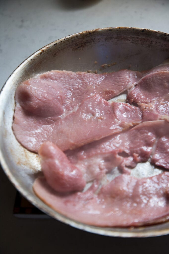 country ham slices in a frying pan