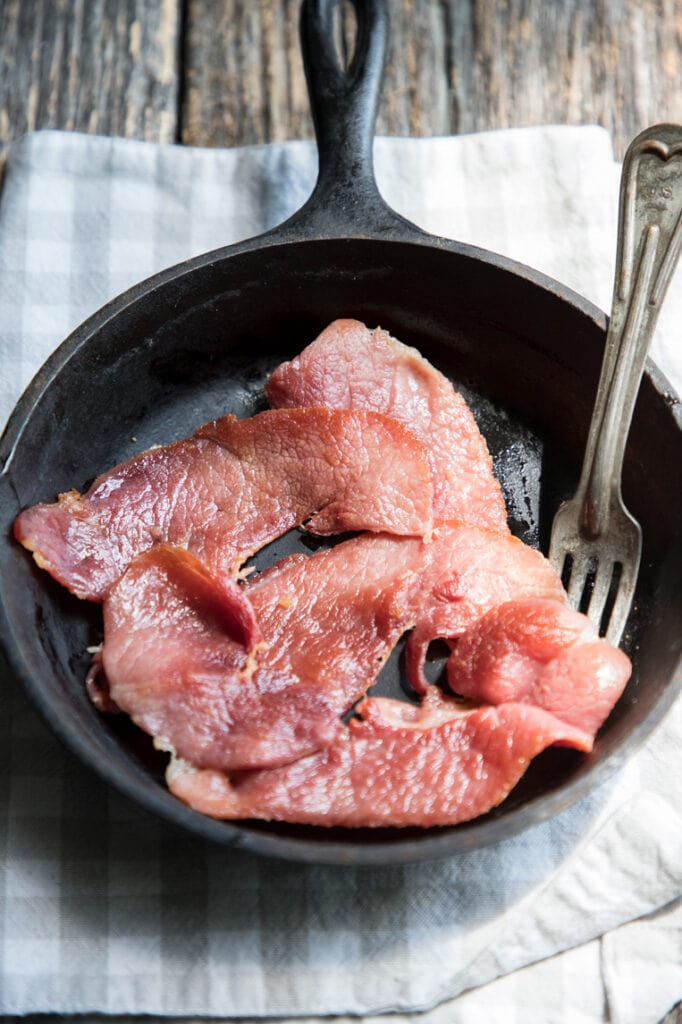 country ham slices in a cast iron skillet
