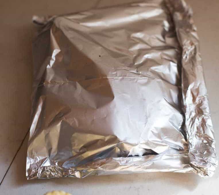 a foil square with the edges folded tightly for baking