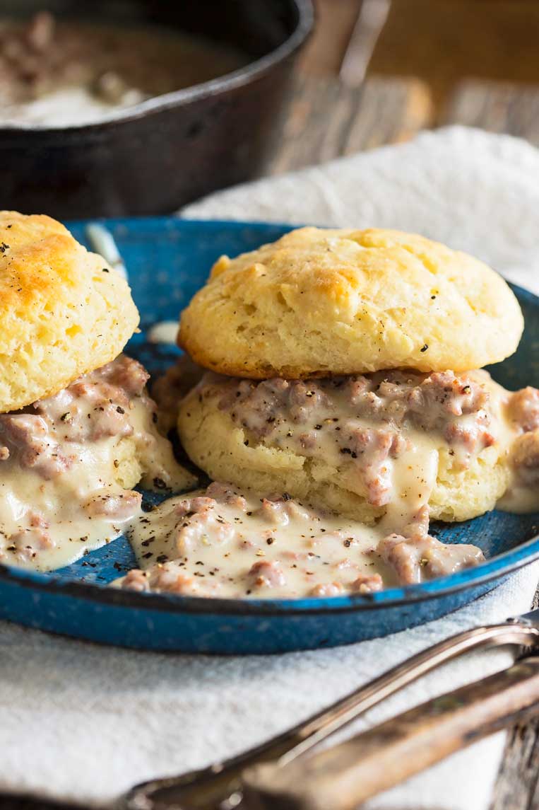 two biscuits and gravy on a plate