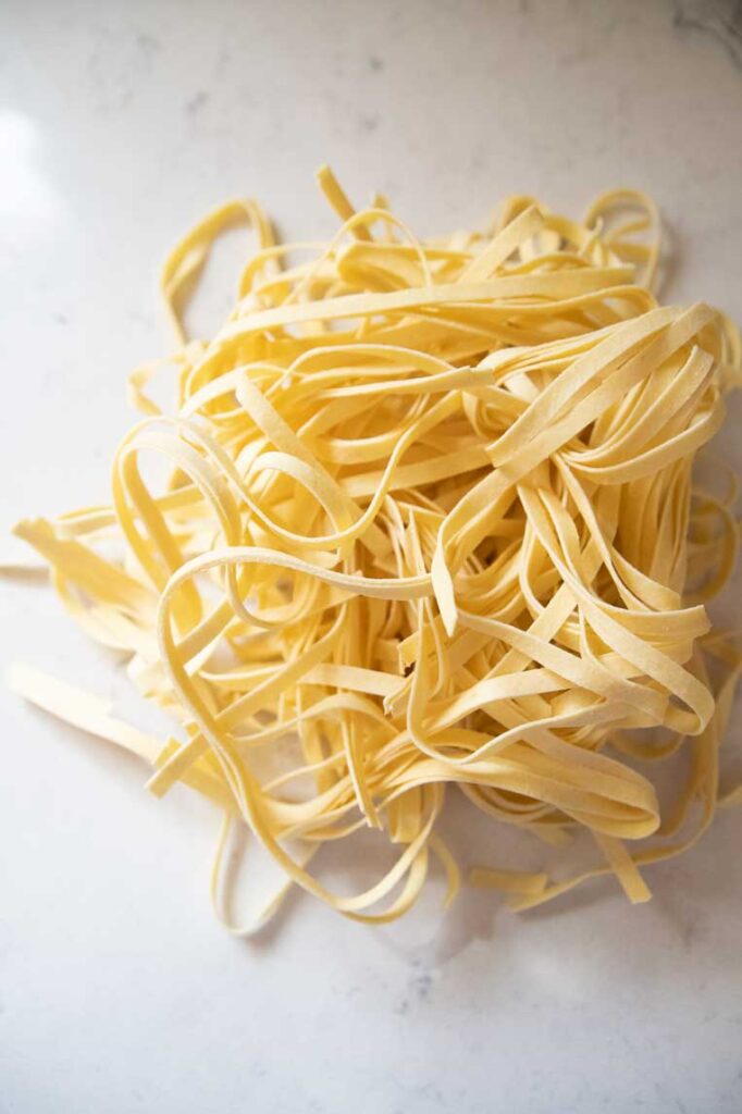a pile of fresh uncooked pasta 