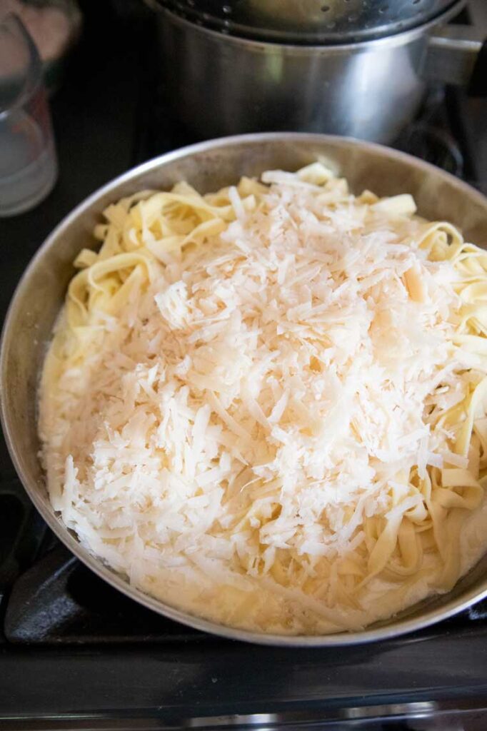 pasta with grated parmesan on top before stirring in 